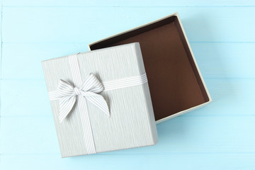 Open gift box on a colored background top view.