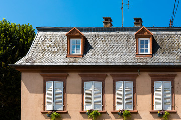 orange house with white shutters in Wissembourg, France