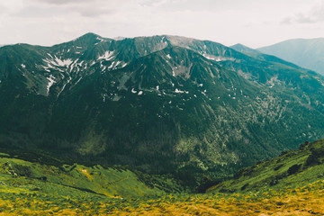 Beautiful panorama of green mountains hills with snow from Kars to Kasprowy Wierch in summer.