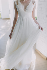 Bride holding modern v neck wedding dress