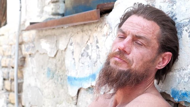 Down-and-out person on the street. Real person with no fixed abode, homeless man