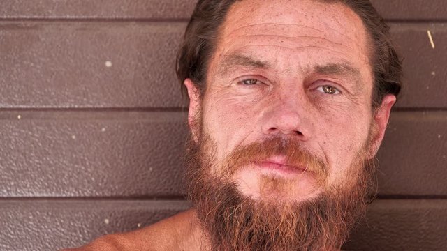 Real down-and-out person with no fixed abode, homeless man close-up