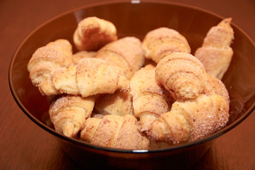 freshly baked croissants on a brown wooden table