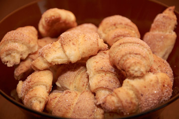 freshly baked croissants on a brown wooden table
