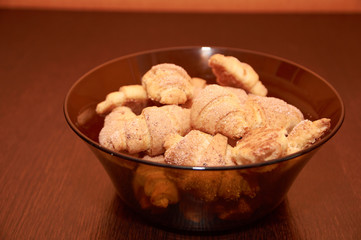 freshly baked croissants on a brown wooden table