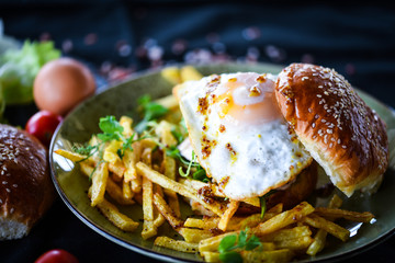 home made chicken burger with fried egg & french fries