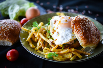 home made chicken burger with fried egg & french fries