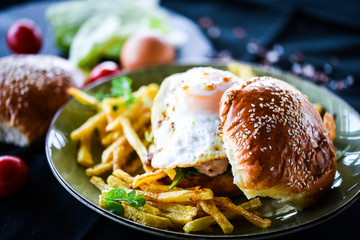 home made chicken burger with fried egg & french fries