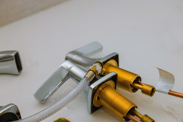 Installs a new faucet for a sink in a bathroom