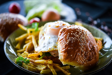 home made chicken burger with fried egg & french fries