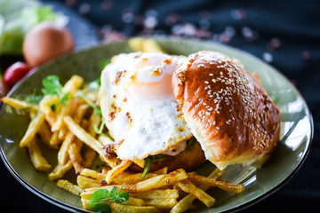 home made chicken burger with fried egg & french fries