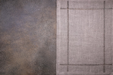 Gray linen tablecloth from right side of brown background