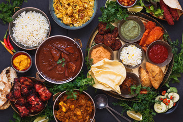Various Indian dishes featuring  rogan josh, chicken tikka masala, biryani, tandoori chicken,...
