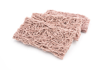 Three stacked rectangular dry Purple noodles are the staple food in China on a white background.