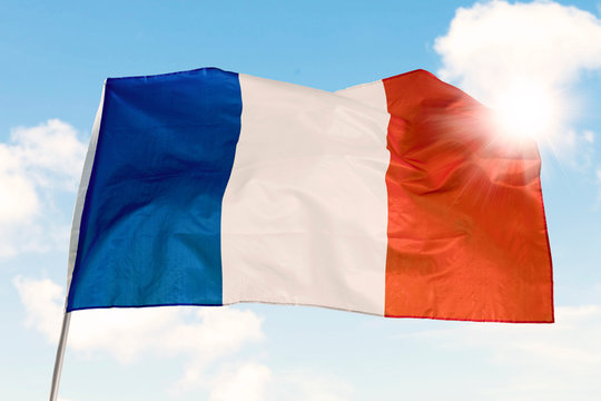 France flag waving  under blue sky