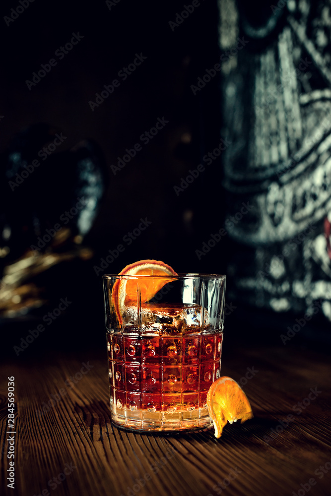 Wall mural sazerac cocktail on dark wooden background with copy space