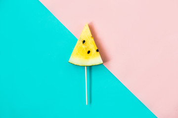 triangular ice cream slices on a stick of ripe yellow watermelon