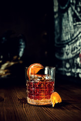 sazerac cocktail on dark wooden background with copy space