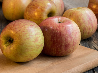 Naklejka na ściany i meble Apples close up on the dark wooden table