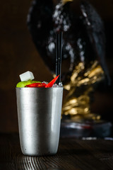 Moscow mule cocktail in copper cup with lime, ginger beer, vodka and mint garnish