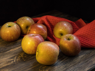 Apples   on the dark wooden table, black background