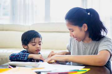 Little boy makes a paper plane with his mother