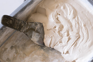 finished solution of the final putty in a plastic container, repair work