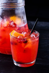 Fresh strawberry lemonade in glass jug, copy space