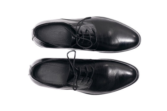 Black leather shoes isolated on a white background.
