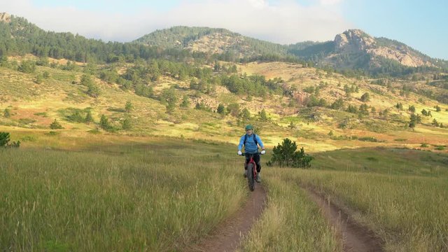 Senior male cyclist is riding a fat mountain bike, summer morning at Lory State Park in northern Colorado foothills