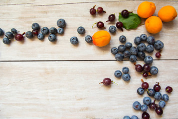 background with blueberries and apricots light tree texture. view from above