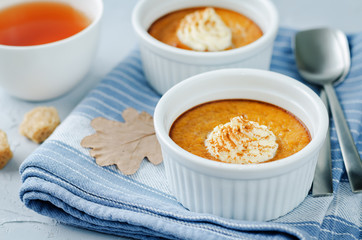 Baked Pumpkin pudding with whipped cream and cinnamon