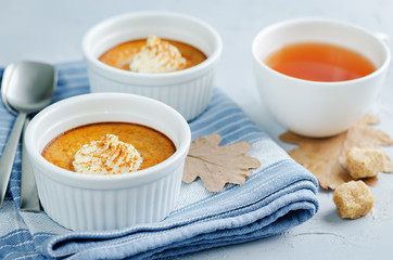 Baked Pumpkin pudding with whipped cream and cinnamon
