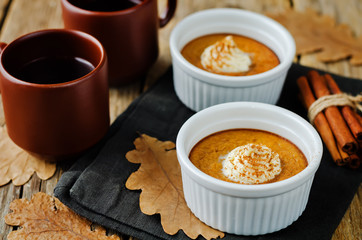 Baked Pumpkin pudding with whipped cream and cinnamon