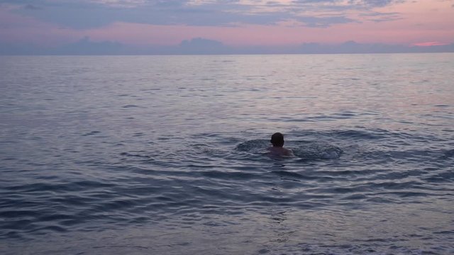 Man swimming in a sea on Kvariati beach. Georgia.