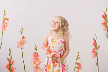 beautiful little blonde girls with  flowers on white background