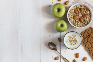 Glass of yoghurt, cereal and apples