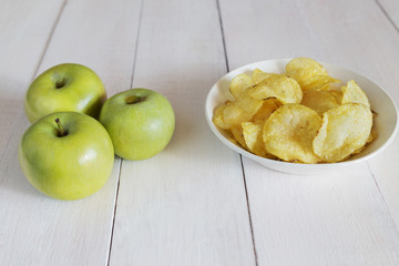 Naklejka na ściany i meble Green apples and a bowl of potato chips