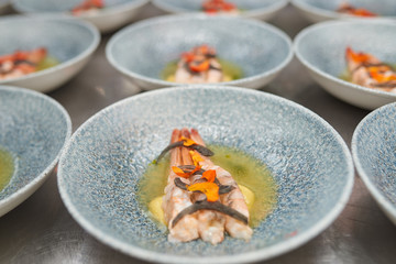 Many plates of shrimp on the kitchen table