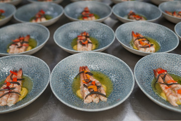 Many plates of shrimp on the kitchen table