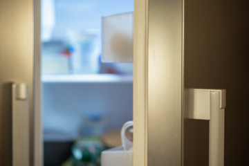 open refrigerator door, blurry background products