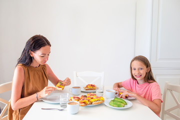 Obraz na płótnie Canvas Happy family having breakfast together in kitchen