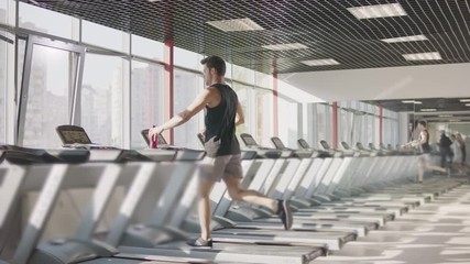 Run workout in gym. Man training exercise on treadmill. Running man