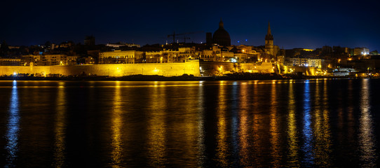 Fototapeta na wymiar View over the Valletta city from Marsans Harbour in night