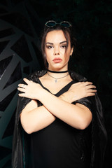 Beautiful goth fashion stylish girl on black studio background