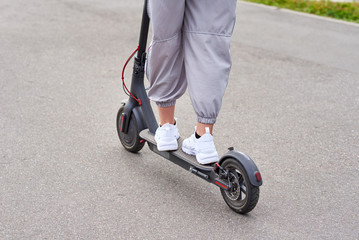 Close up of man driving on electric scooter in the city