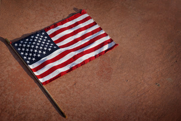 American flag that has fallen on ground