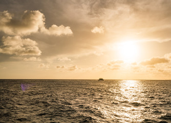Sunset over the sea from a house and swimming pool
