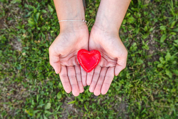 woman hands holds red heart