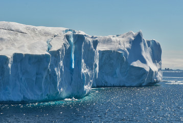 Two Icebergs Abutted with One Face Fracturing on Sunny Day in Antarctica